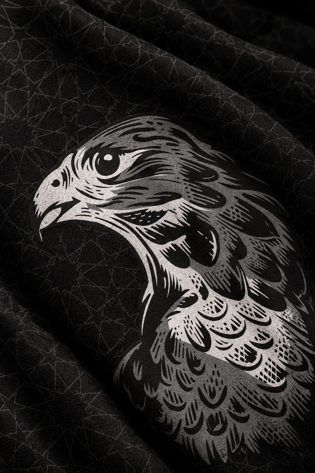 Falcon artwork printed across folded charcoal cotton